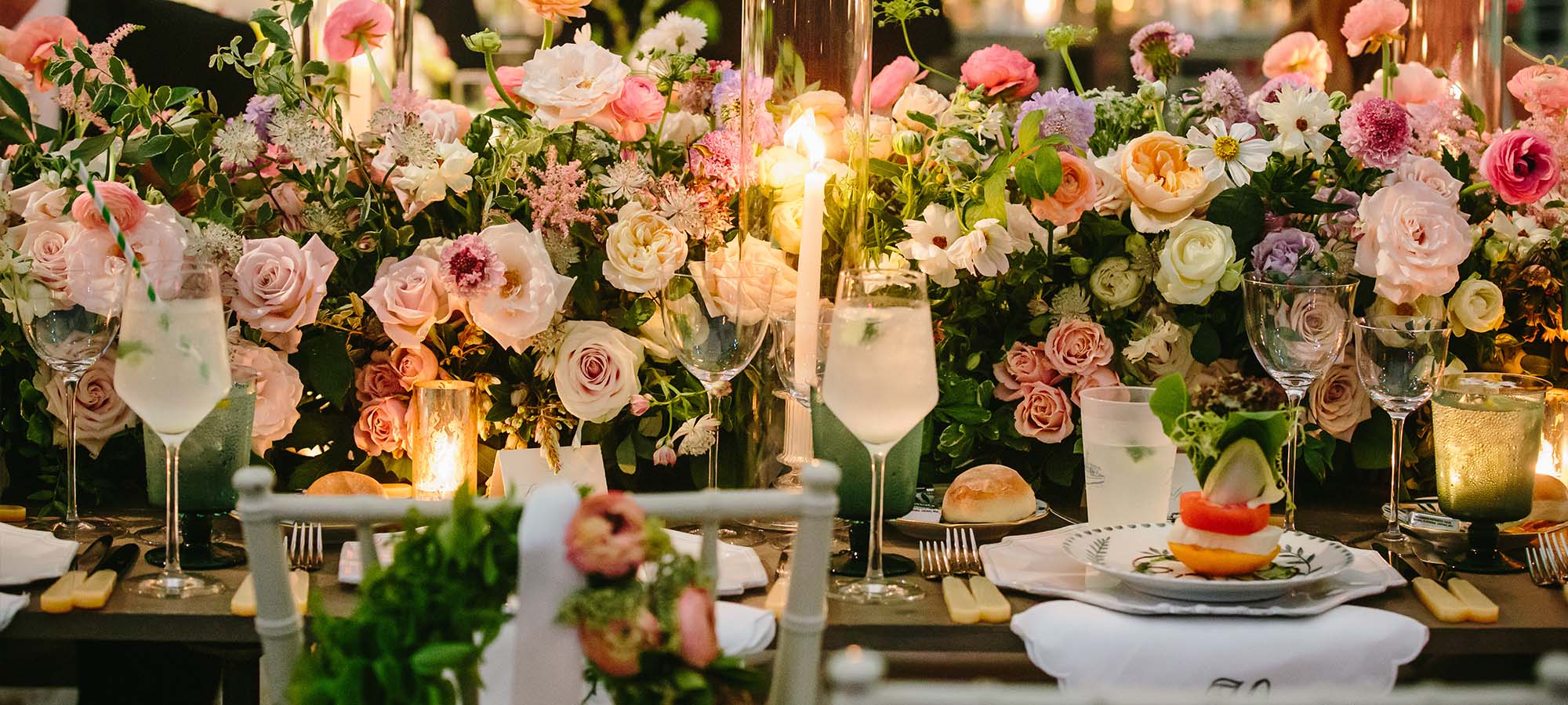 Spring salad on wedding tables with florals